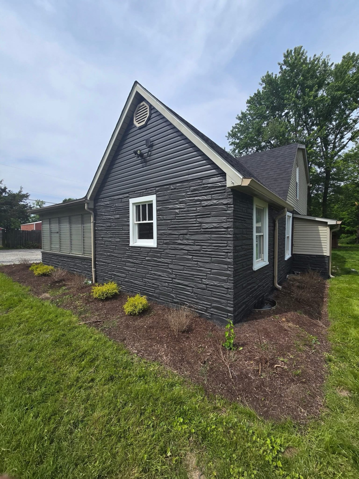 Charcoal-painted house with contrasting light window trim